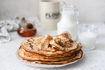 Stack of traditional russian pancakes blini on wooden background. Maslenitsa traditional Russian...