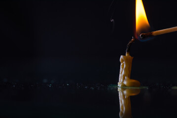 Burning candle, smoke on a dark background.