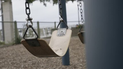 Empty Playground with Swing Swinging