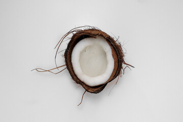 half of the coconut in the middle of a white background