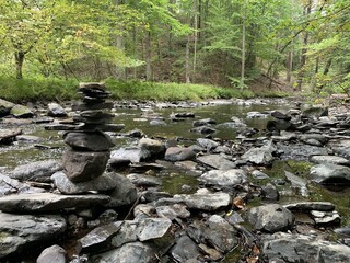 river in the forest and stone pyramid