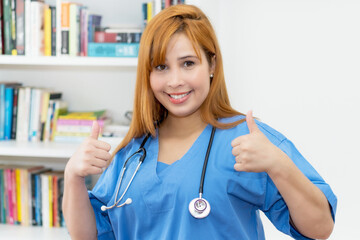 Laughing redhead nurse showing thumbs up