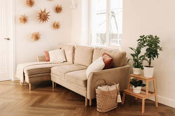 Bright minimalistic interior of a cozy living room with sofa cushions and a window in a Scandinavian interior in a comfortable apartment. Selective focus