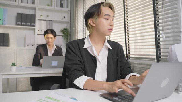 Asian handsome businessman gay people working in office with happiness