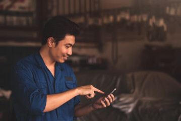 Professional auto mechanic working in a repair shop , car garage.