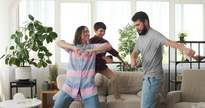 Crazy family having fun dancing at home