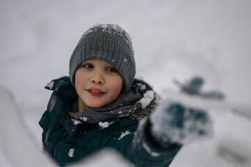a boy walks in a snow park