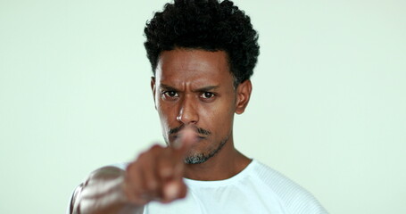 Upset African man pointing finger arguing. Black man in argument gesturing blaming