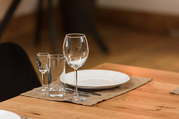 Glass dishes on a wooden table. clean and empty. cozy atmosphere. serving a banquet
