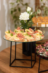 bruschetta with prosciutto ham and figs with cheese. fresh basil. italian appetizer.