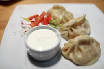 Manti with sauce on plate