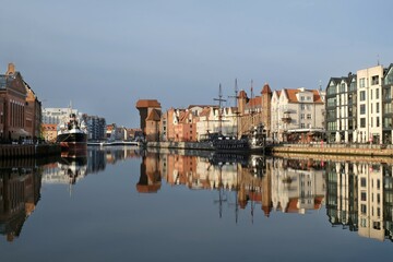 Panorama of Old Town in Gdansk and Motlawa river with ships, Poland. Amazing reflections in water.