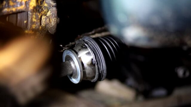 installation of a new CV joint on a car drive in a car service