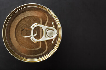 A can with a metal lid and a ring for opening