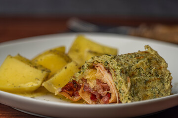 Courgette roll with ham and bacon and cheese with potatoes