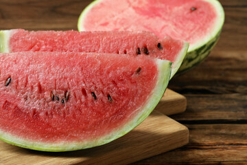 Slices of tasty ripe watermelon on wooden table, closeup