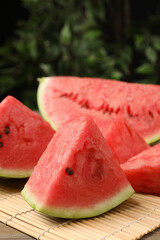 Slices of tasty ripe watermelon on wooden table