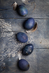Dyed Easter eggs with marble stone effect painted with natural dye carcade tea from hibiscus flowers on old background