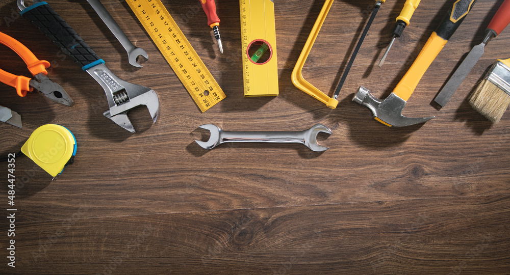 Wall mural work tools on the wooden background.