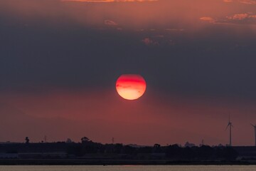 Beautiful lagoon landscape background with sun setting in the clouds