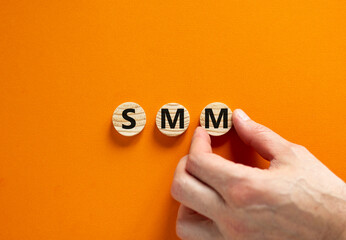 SMM, social media marketing symbol. Concept word SMM social media marketing on wooden circles on beautiful orange background, copy space. Business, SMM social media marketing concept.
