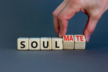 Soul and soulmate symbol. Businessman turns wooden cubes and changes the concept word Soul to...