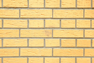 Background, texture of a yellow brick wall.Facing brick