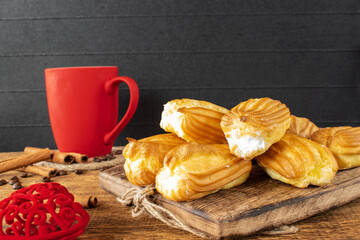 Cake with white protein cream and a cup of coffee.Food on the table. Selective focus.
