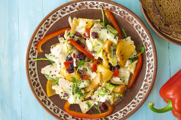 Fototapeta na wymiar Salad with chicken and cheese, with herbs, persimmons, bell peppers. The concept of diet food. Delicious salad in bowl on wooden background, top view, banner 