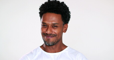 Grateful African man portrait giving thanks, faith gesture with hands smiling to camera, feeling compassion