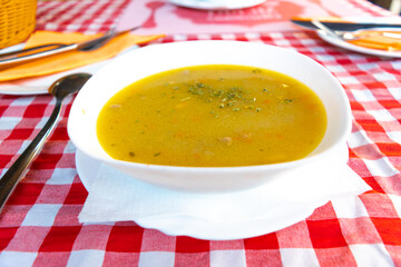 Serbian national dish soup veal corba along with bread in the background.