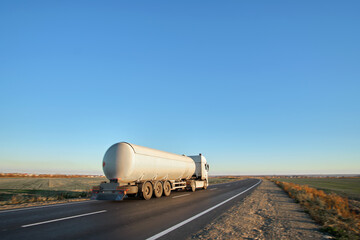 Petrol cargo truck driving on highway hauling oil products. Delivery transportation and logistics...