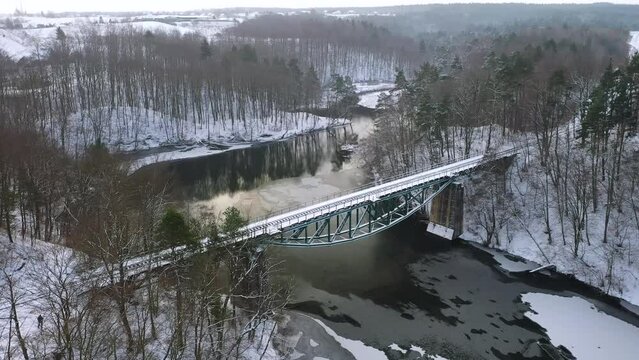 Winter scenery of the railway bridge in Rutki over Radunia river, Kashubia. Poland