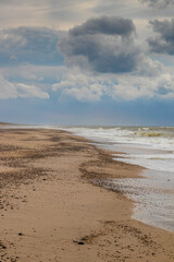 clouds over the beach at the north sea on a stormy day