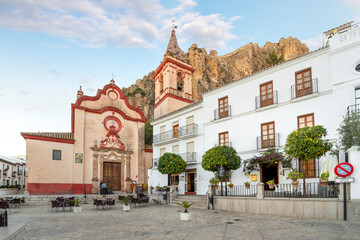 Fototapeta premium The pastel-pink baroque Church of Santa María de la Mesa in the Catalonian White Village of Zahara de la Sierra, in the Cádiz, Spain Province.