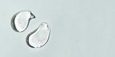 Transparent hyaluronic acid gel on a gray background.