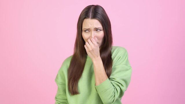 Frustrated lady not like smelly scent ignore isolated pastel color background