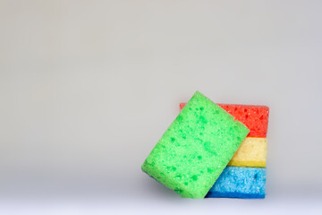 Multicolored sponges for cleaning. blue, green, red, yellow, blue and green colors. space for text.
Kitchen cleaning set sponge background. 