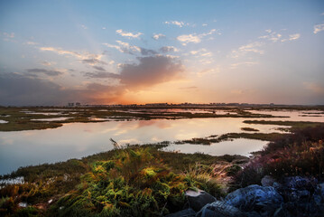 View of Punta Umbria from the marshes of Huelva Spain, in a beautiful sunset with a sky full of...