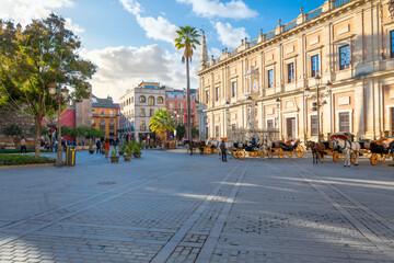 Horses for hire line up near the cathedral and Royal Alcazar in the historic Barrio Santa Cruz Plaza del Triunfo of Seville, Spain at Plaza del Triunfo. © Kirk Fisher