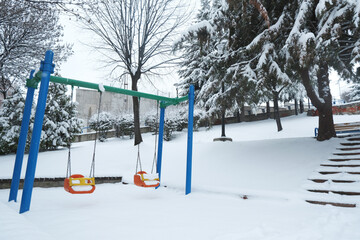 Swing in park in winter day