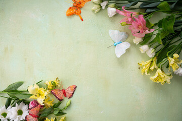 Green spring background with flowers top view copy space