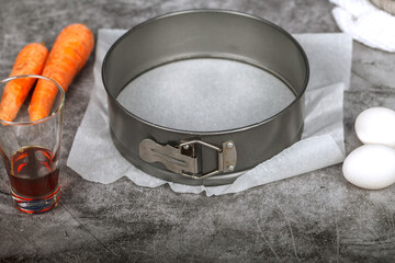 An empty round cake pan lies on the table