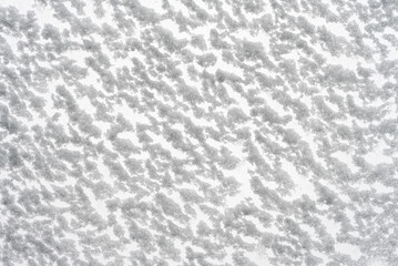 White snow texture. Snow-covered glass bottom view. Christmas and New Year background.