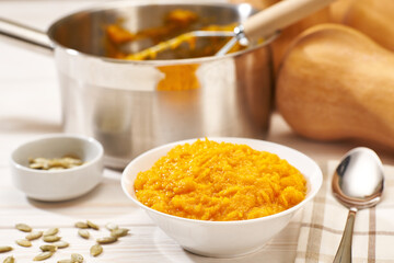 Making pumpkin puree on a white wooden table, selective focus.