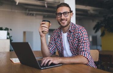 Millennial businessman working at desk in office