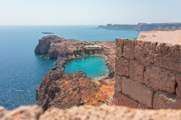 Panorama of the secret beach in Lindos city from the Acropolis, Rhodes island, Greece