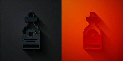 Paper cut Tequila bottle icon isolated on black and red background. Mexican alcohol drink. Paper art style. Vector