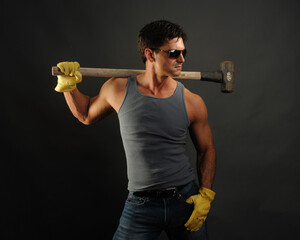 The sexy construction man poses for the photo.