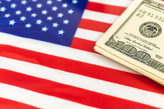 USA money laundering. Dollar bills over the American flag. Criminal and outlaw concept background photo